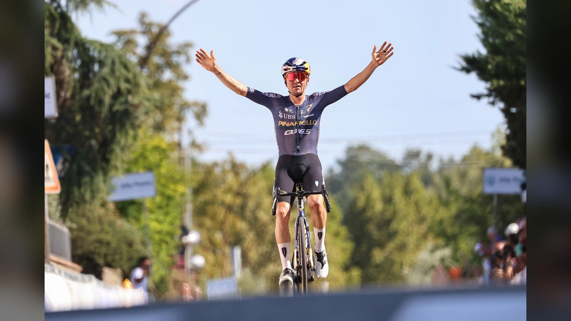 Tom Pidcock celebrates a road race victory