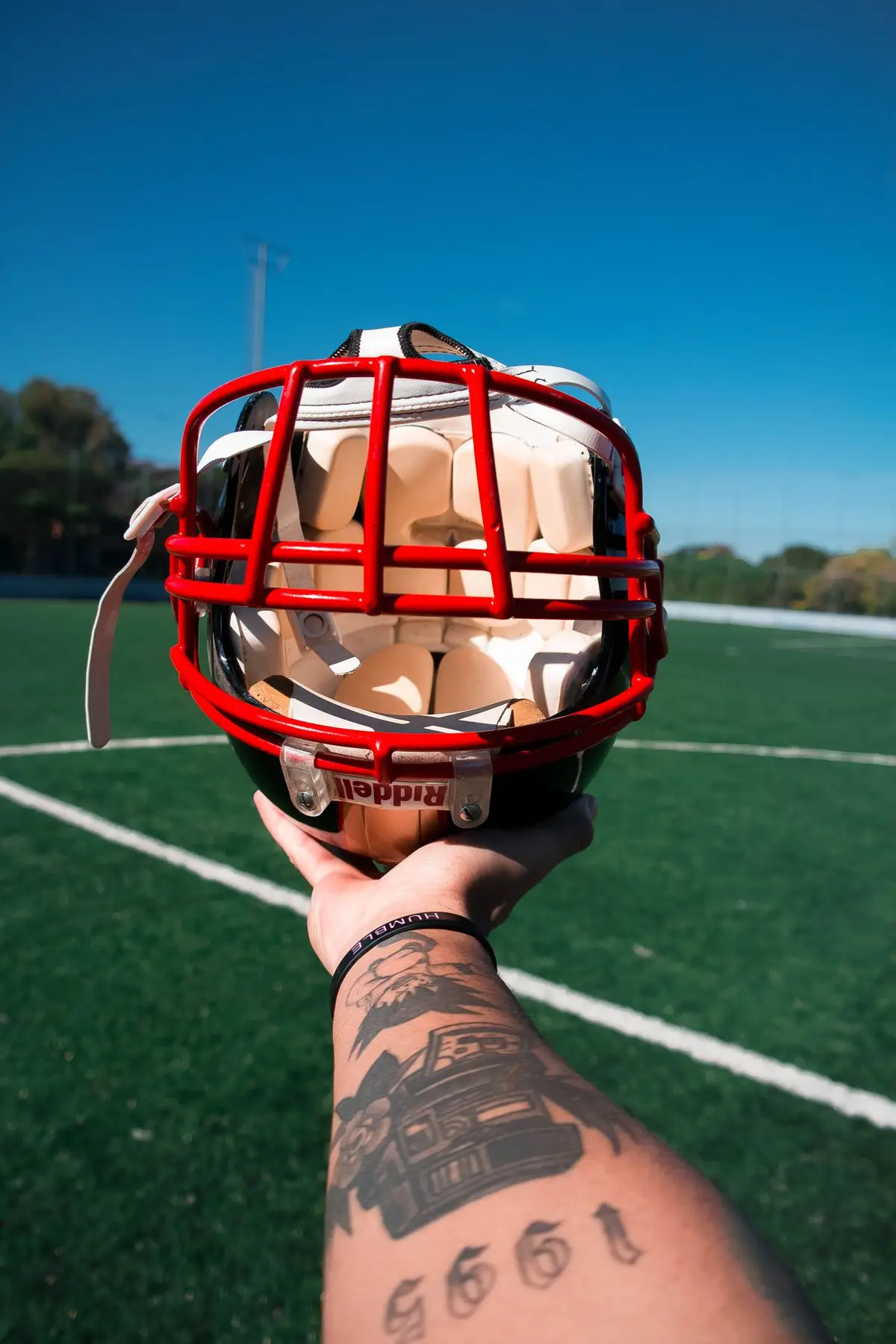 American football helmet with red facemask