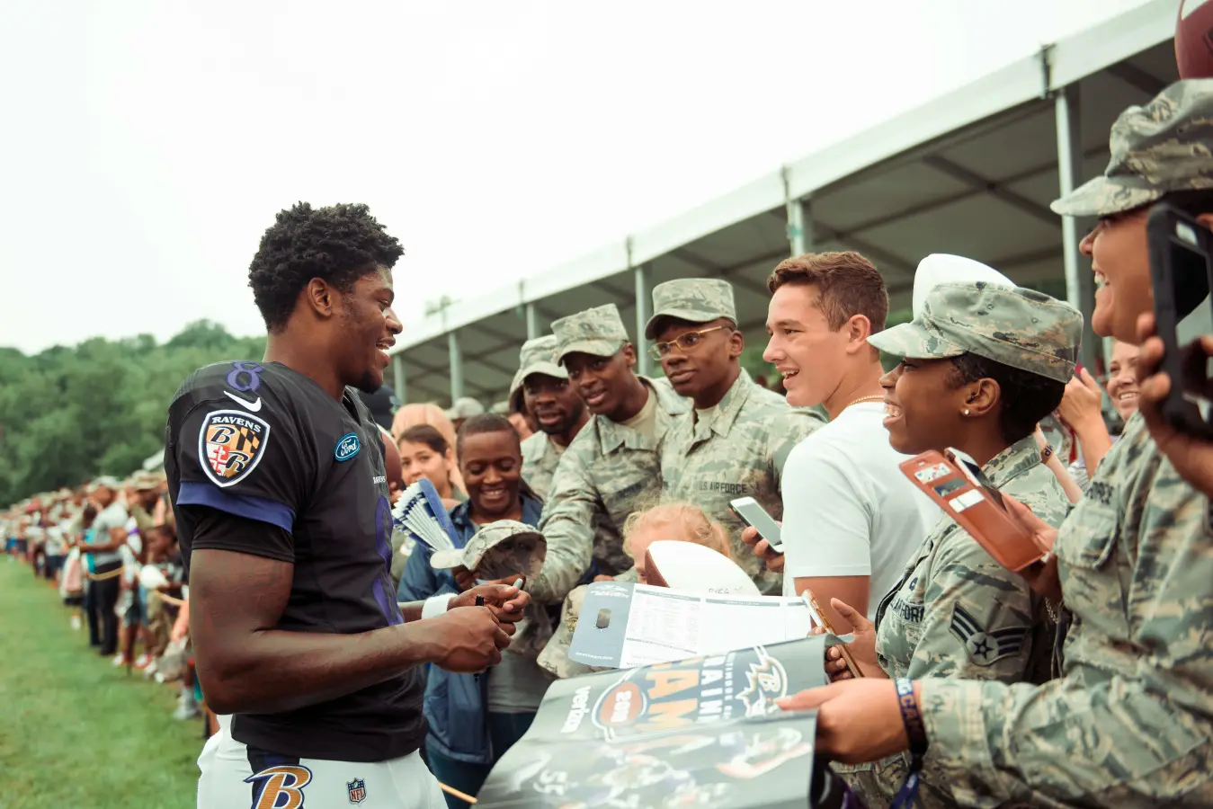 Lamar Jackson with Baltimore Ravens supporters at a 2018 team event