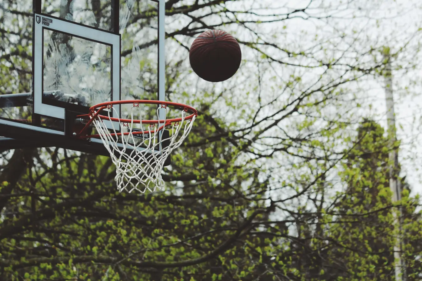 Basketball approaching an outdoor hoop