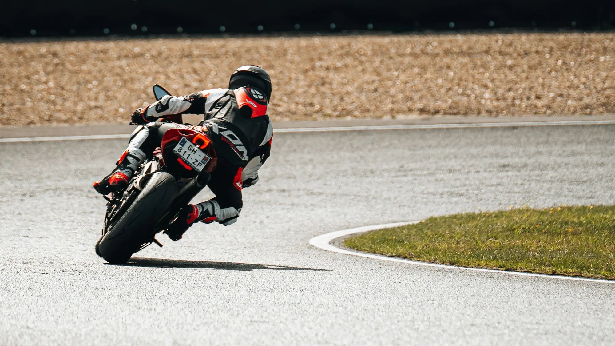 Motorcycle racer cornering on a paved circuit