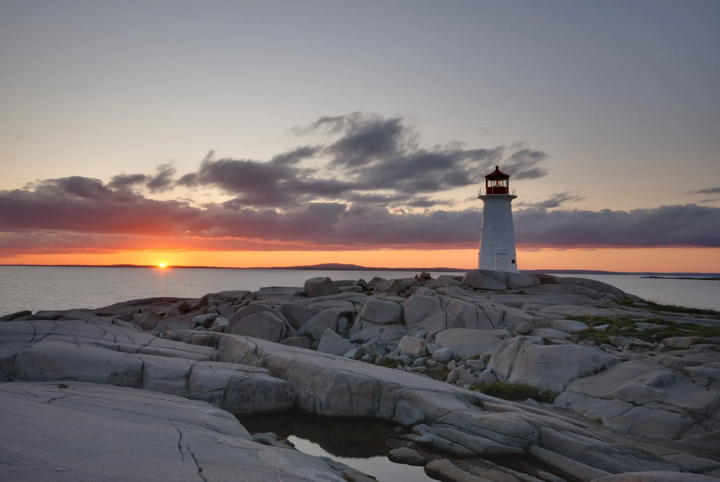 Peggy's Point Lighthouse at sunset in Nova Scotia