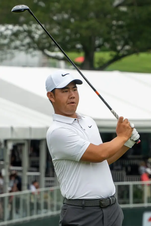 Tom Kim playing an approach shot during competition