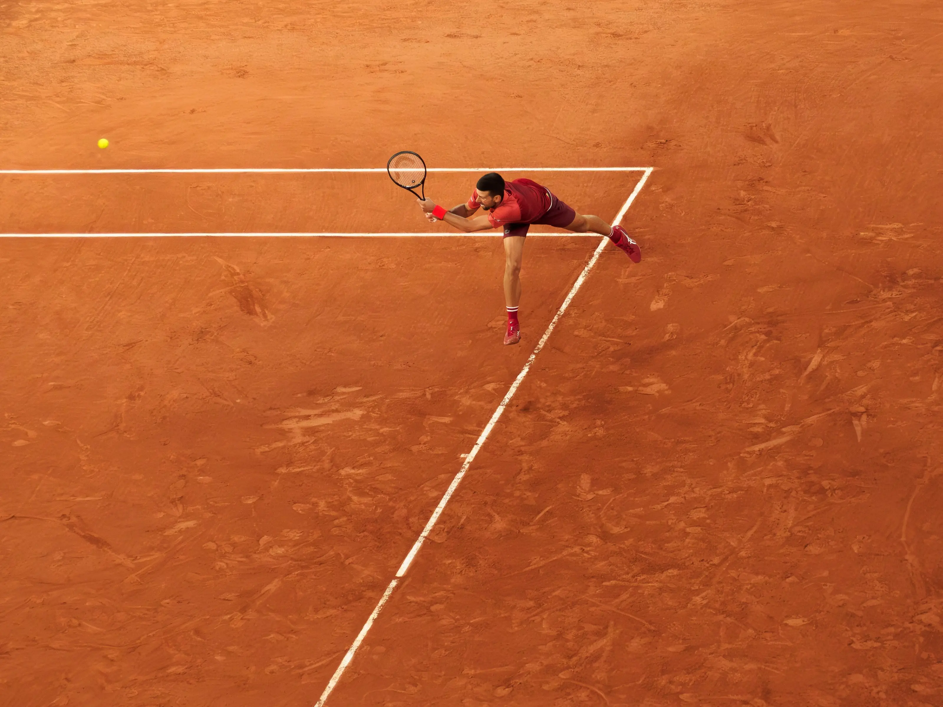 Novak Djokovic returning serve during a professional tennis match