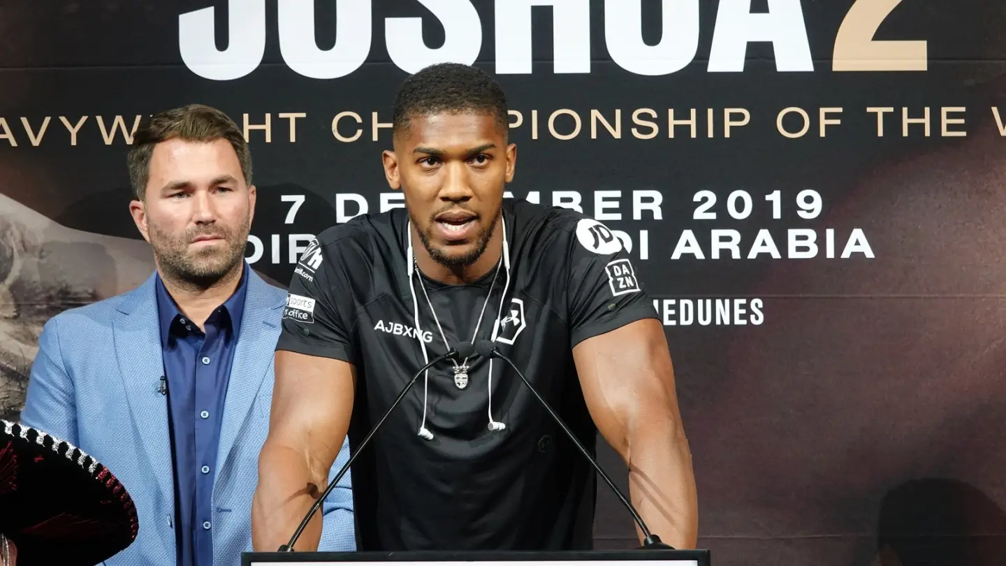 Anthony Joshua speaking at a press conference with promoter Eddie Hearn