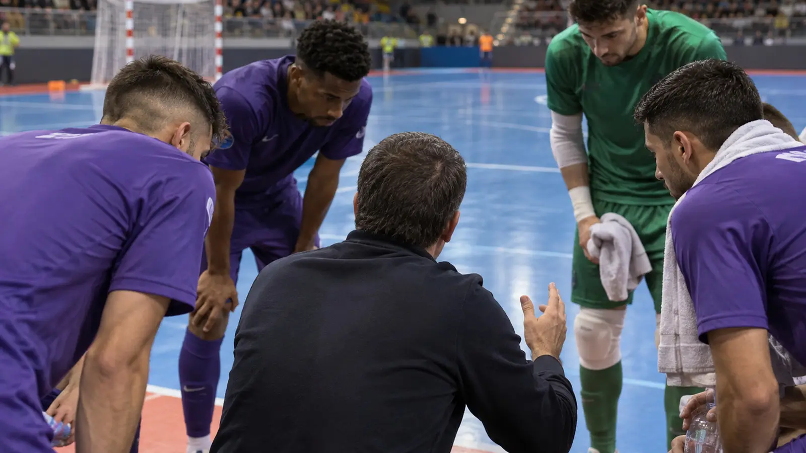 Conceptual futsal team tactical huddle at timeout