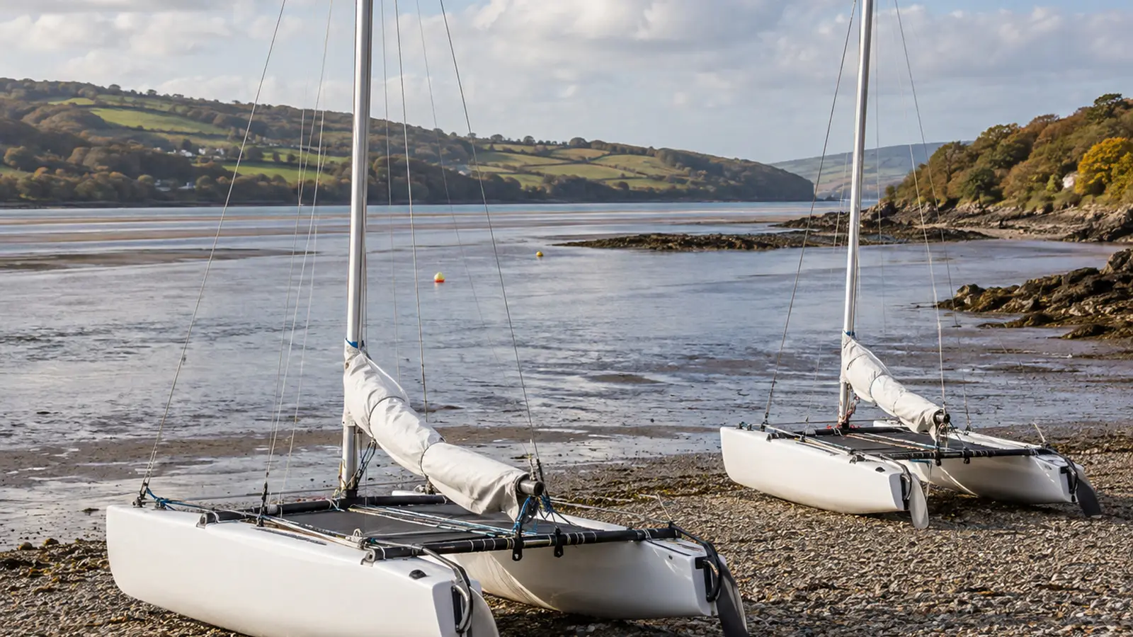 Conceptual Dart 15 catamarans ashore on a Devon estuary