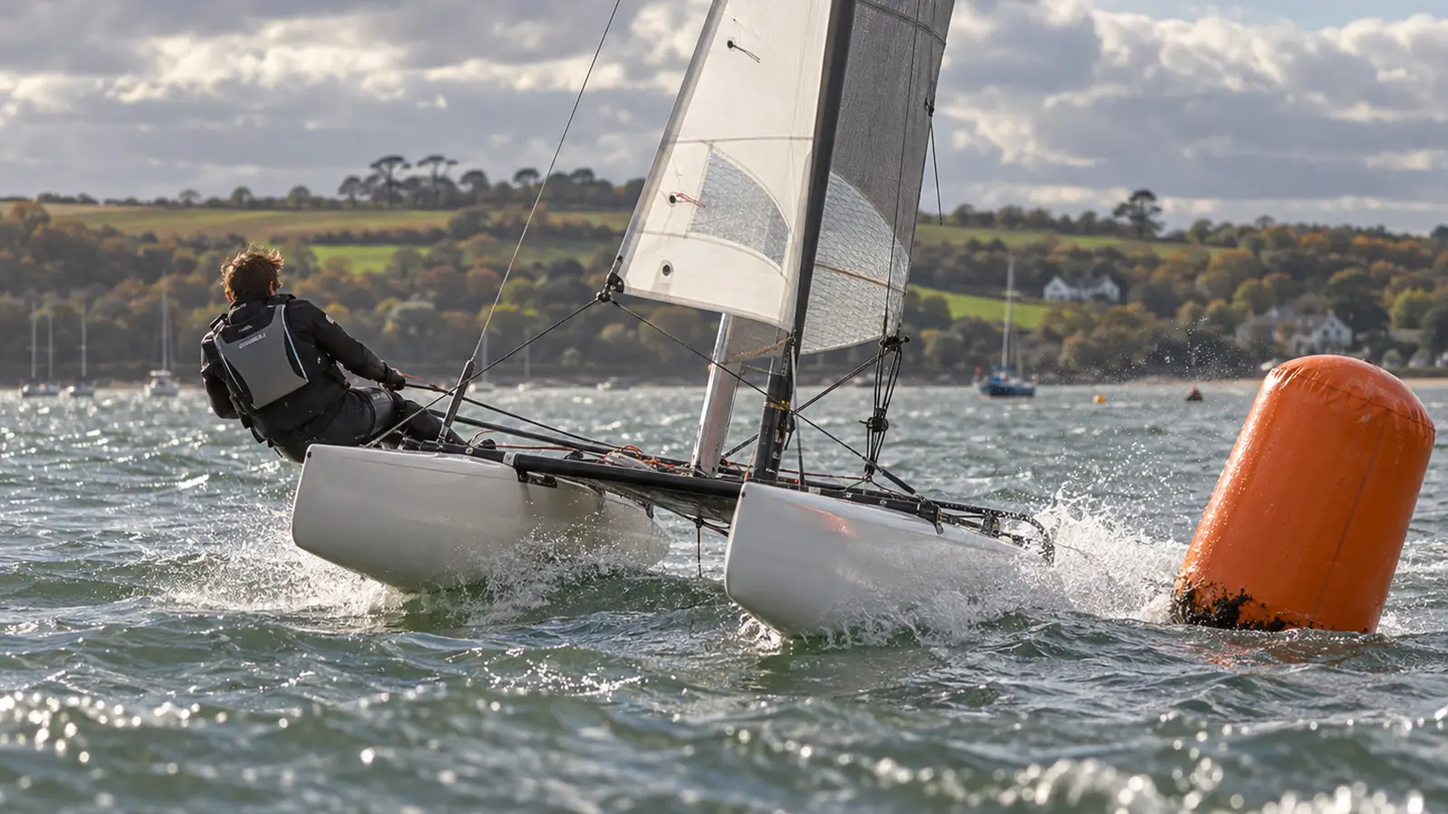 Conceptual Dart 15 catamaran rounding a buoy