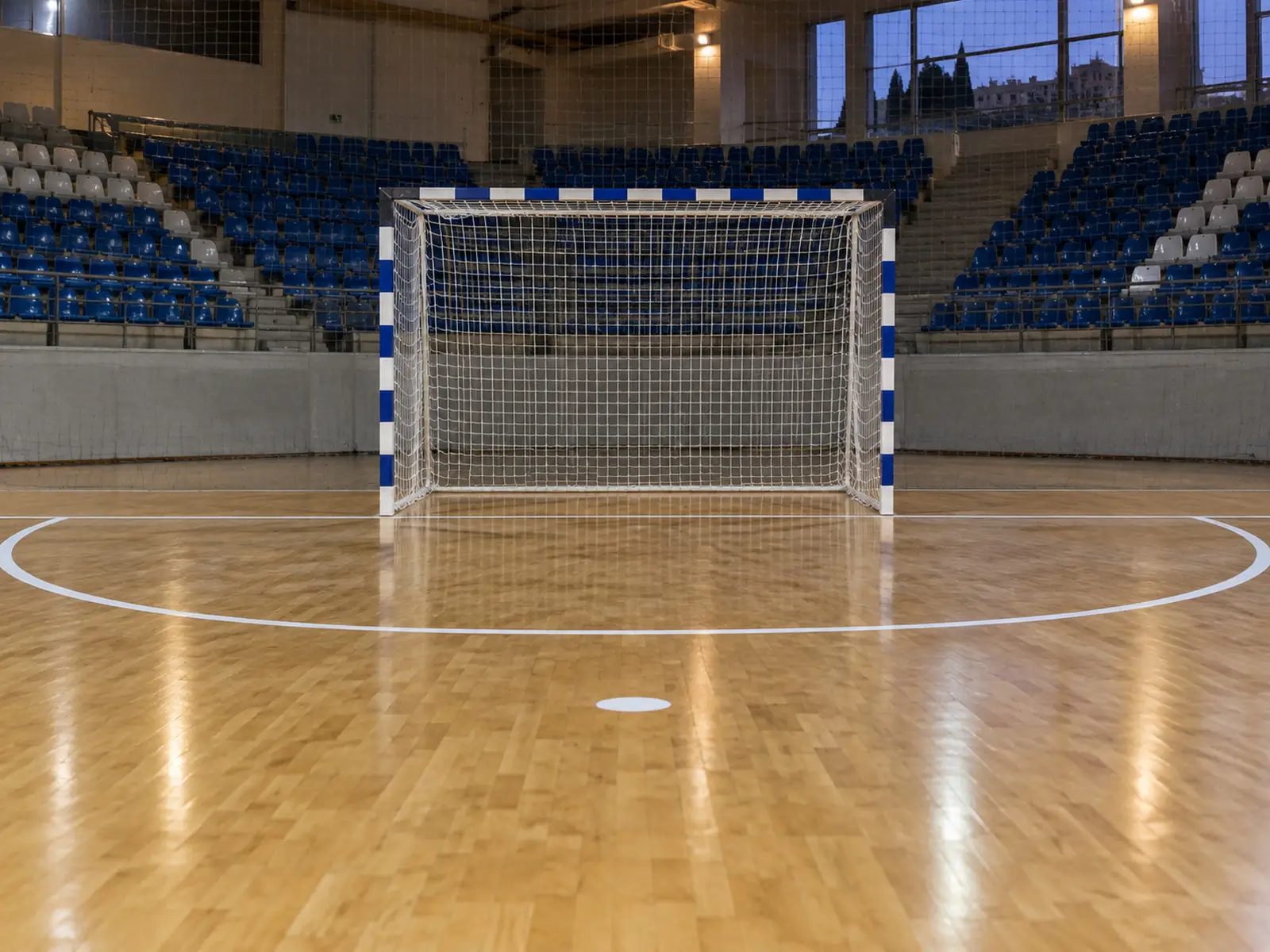 Conceptual image of an empty futsal goal inside an arena