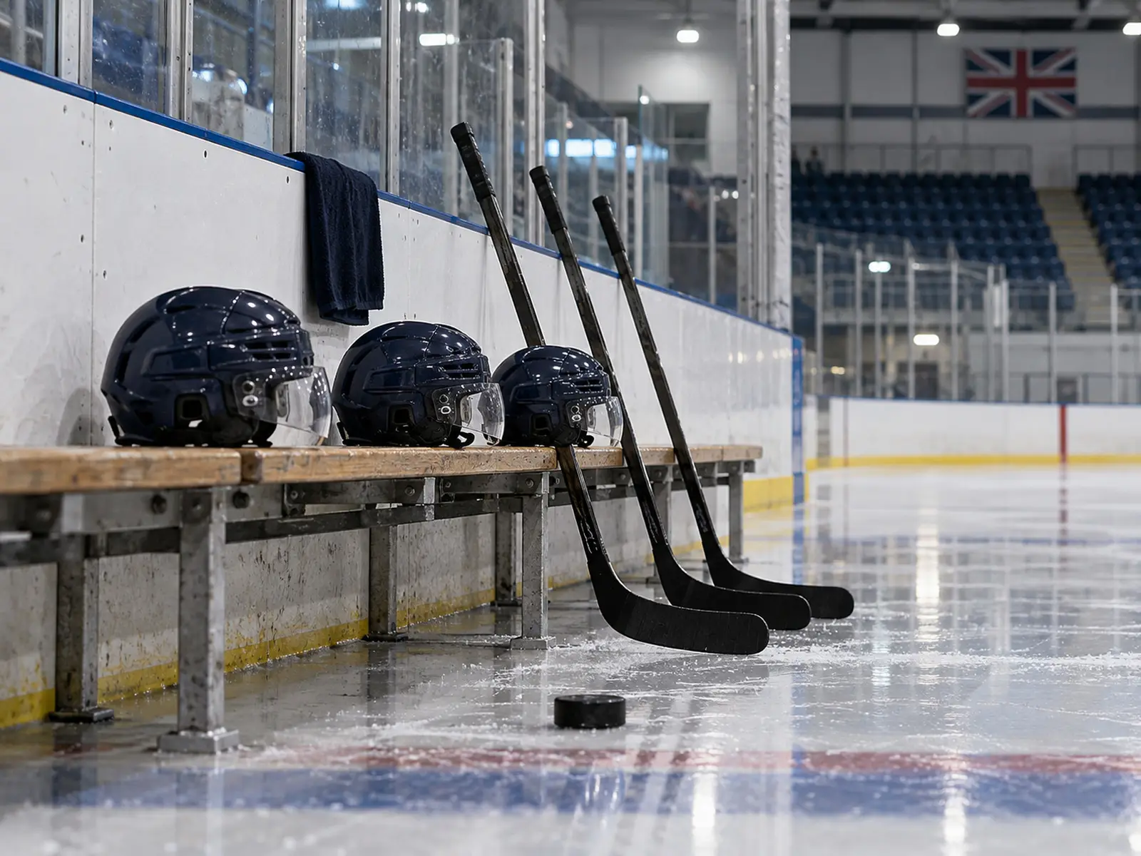 Conceptual image of ice hockey helmets and sticks beside the players bench
